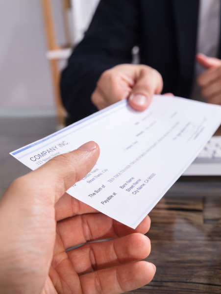 Photo of person handing check
