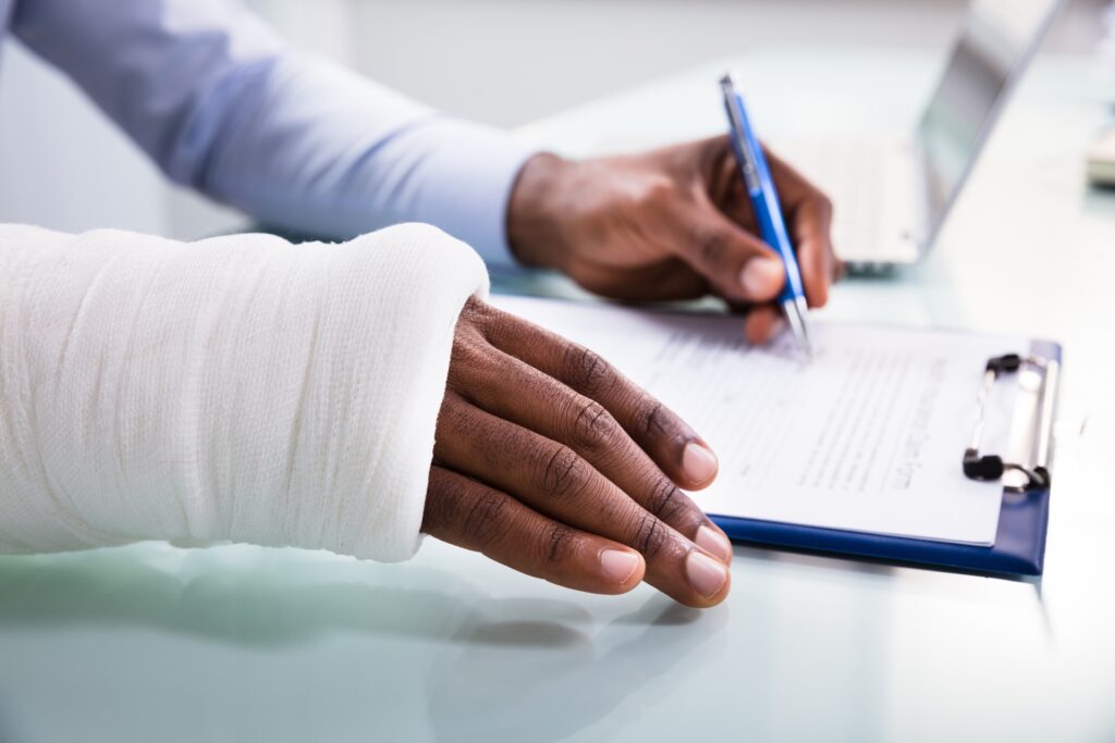 Photo of a Person Writing with Injured Hand